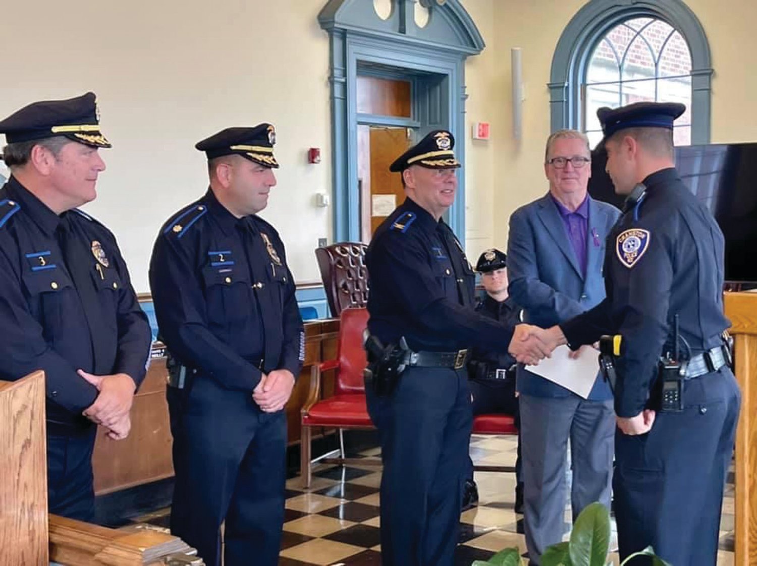 CHIEF’S CONGRATULATIONS:  Chief of Police Col. Michael Winquist congratulates Officer Michael Schiappa during last week’s ceremony. Looking on, from left, are Maj. Robert Quirk, Maj. Todd Patalano and Mayor Ken Hopkins.
